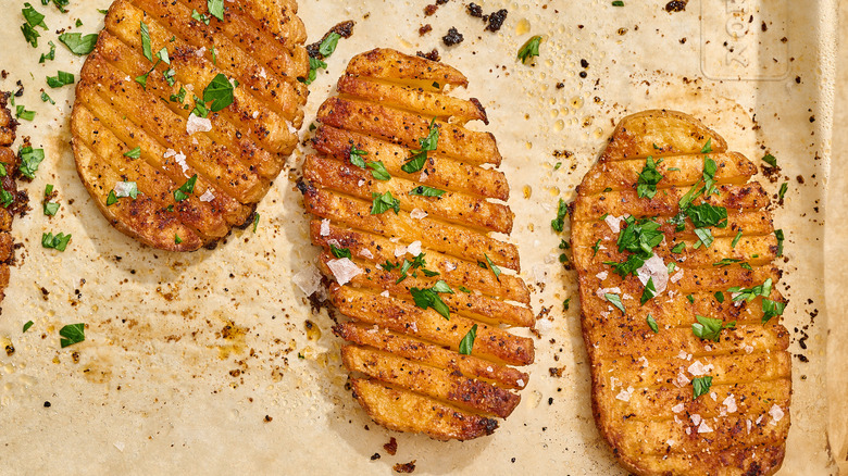 crispy accordion potatoes on a sheet tray