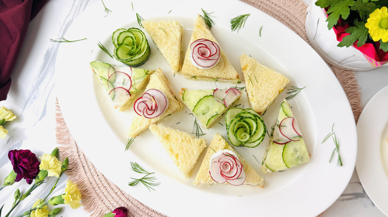 Tea sandwiches garnished with radish and cucumber flowers