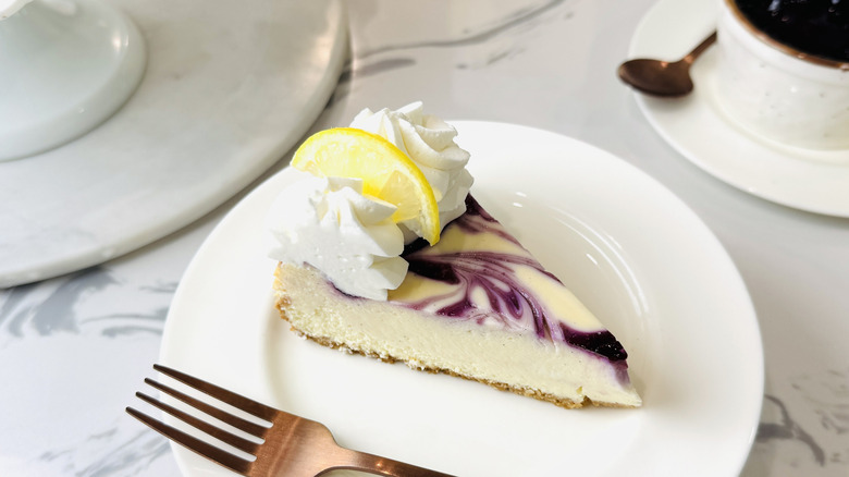 Slice of blueberry lemon cheesecake
