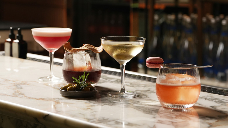 Fancy cocktails lined up on a bar