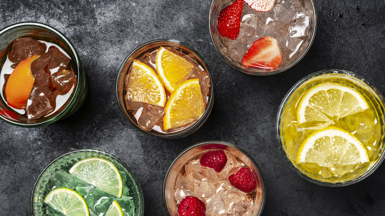 Birds-eye view of five colorful drinks with ice