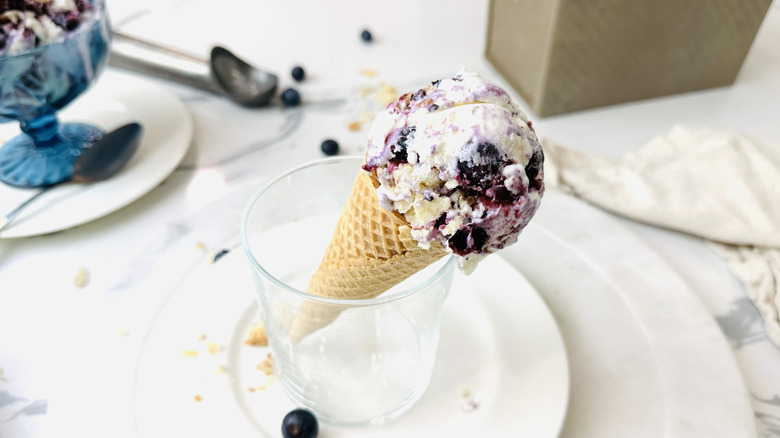 Blueberry pie ice cream cone sitting in glass