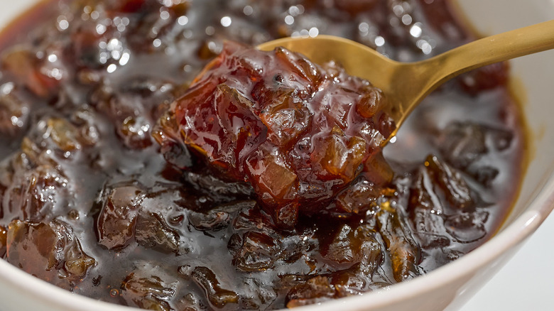 onion jam on a spoon lifting out of a bowl