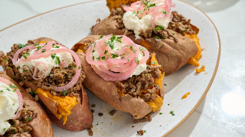 loaded beef sweet potatoes on a platter