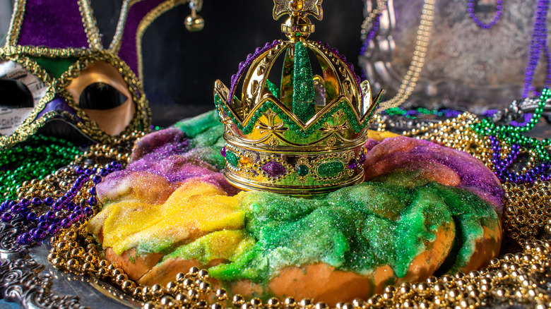 Mardi Gras king cake with crown and beads