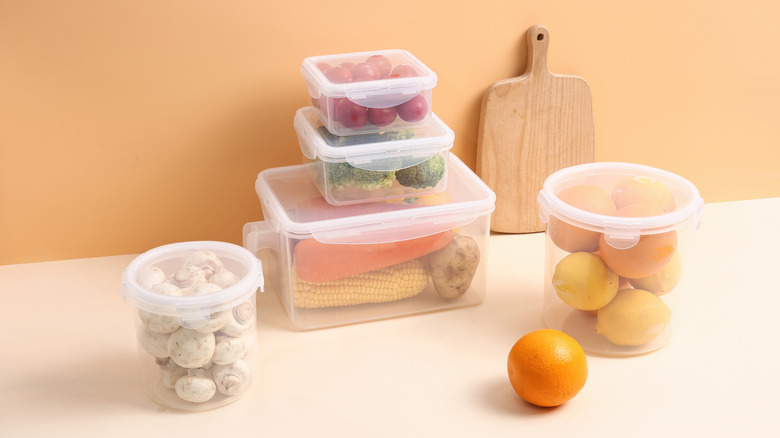 Different plastic containers with various foods inside