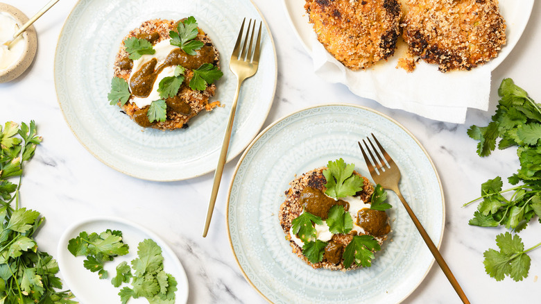 Two sweet potato crab cakes with mayonnaise and chermoula