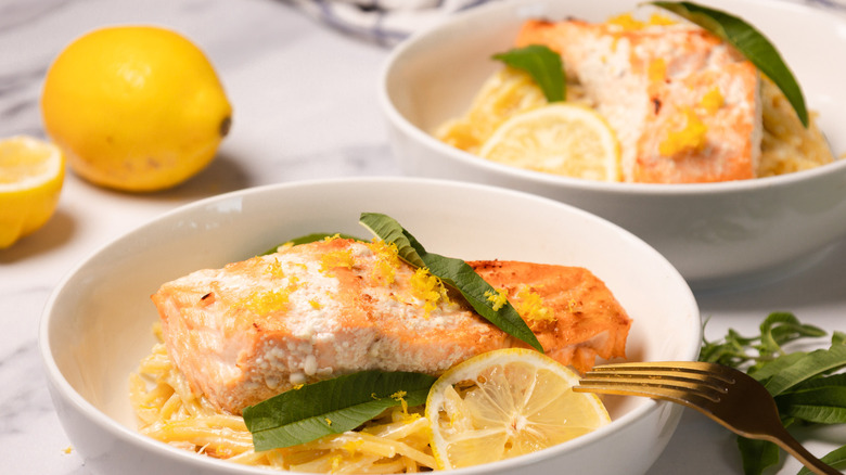Two bowls of creamy citrusy salmon pasta.