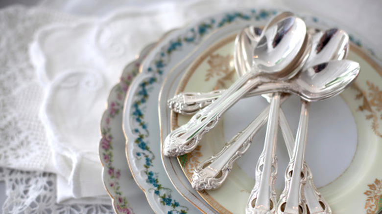 Vintage plates with spoons on a table