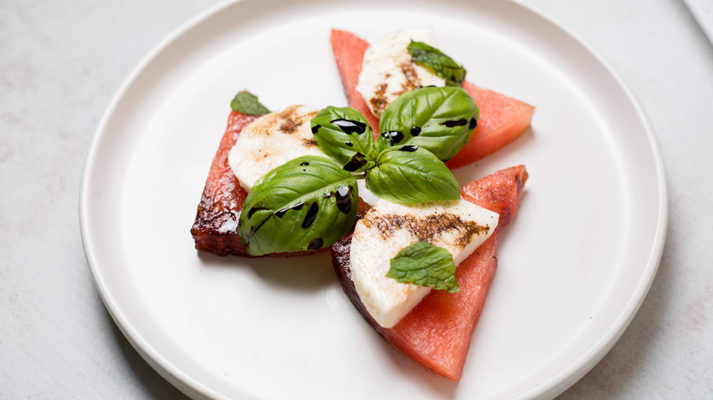 watermelon caprese salad serving on white plate