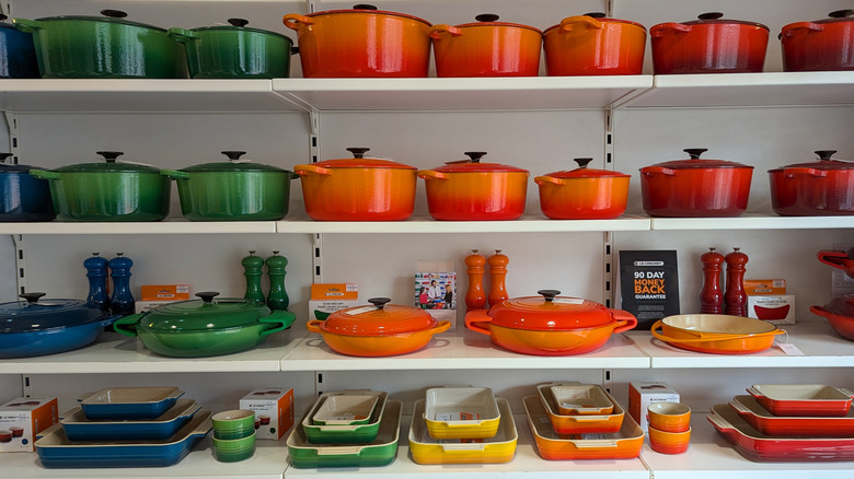 Store display of various Le Creuset pieces in different colors.