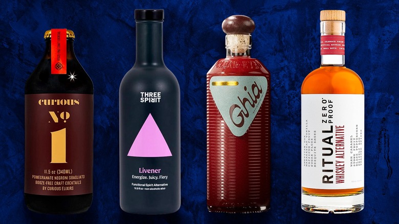 Four bottles of non-alcoholic spirits on blue background