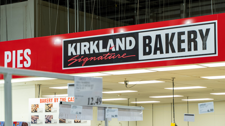 Red store banner inside Costco warehouse reading pies and Kirkland Signature bakery