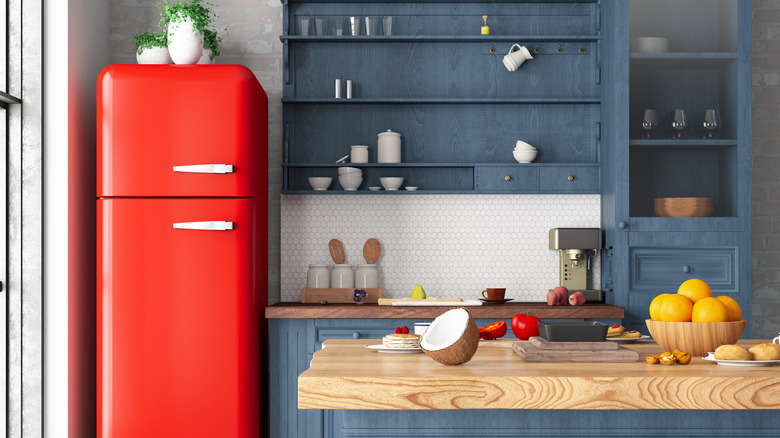 red fridge in kitchen with plants on top