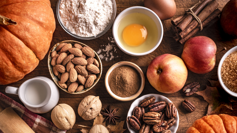 Pumpkins, apples, and baking ingredients on counter