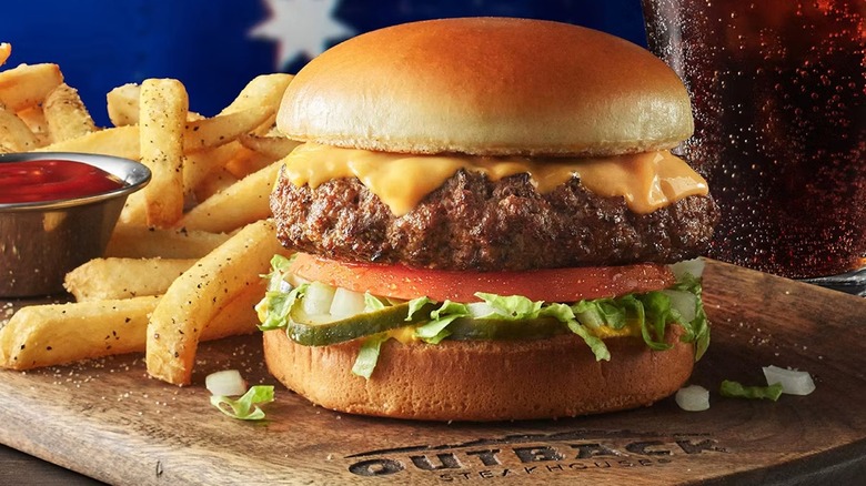 Outback Steakhouse burger beside fries and a drink