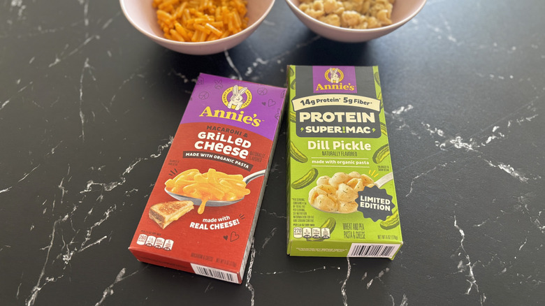 Annie's mac and cheese boxes with bowls of mac and cheese in background