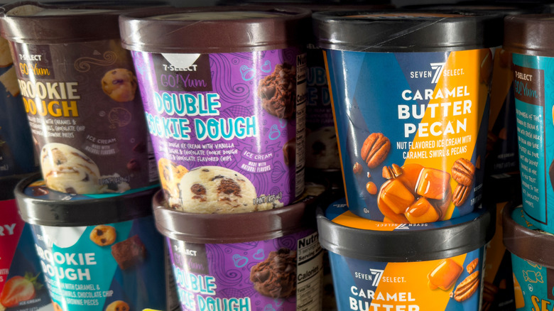 Various 7-Select ice cream pints displayed in a store.