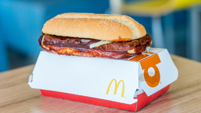 McDonald's McRib on top of box inside the restaurant.