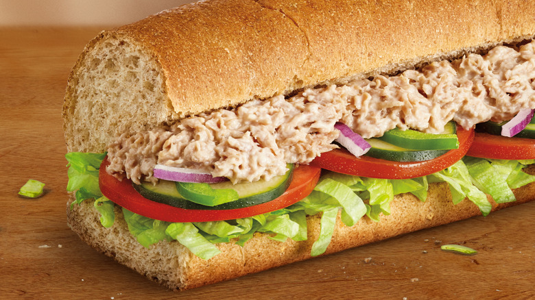 Subway tuna salad sandwich on top of wooden table