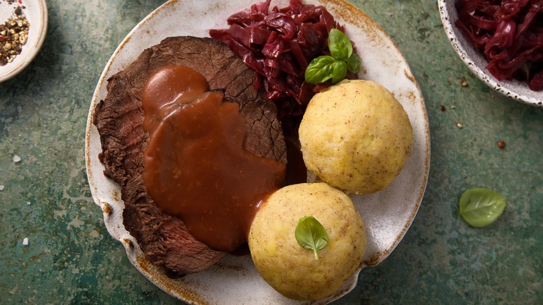 German sauerbraten with potato dumplings and red cabbage