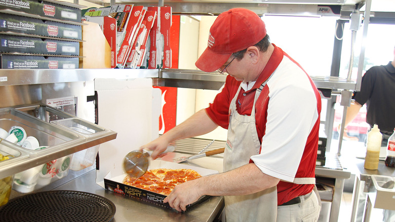 Papa John's employee making pizza