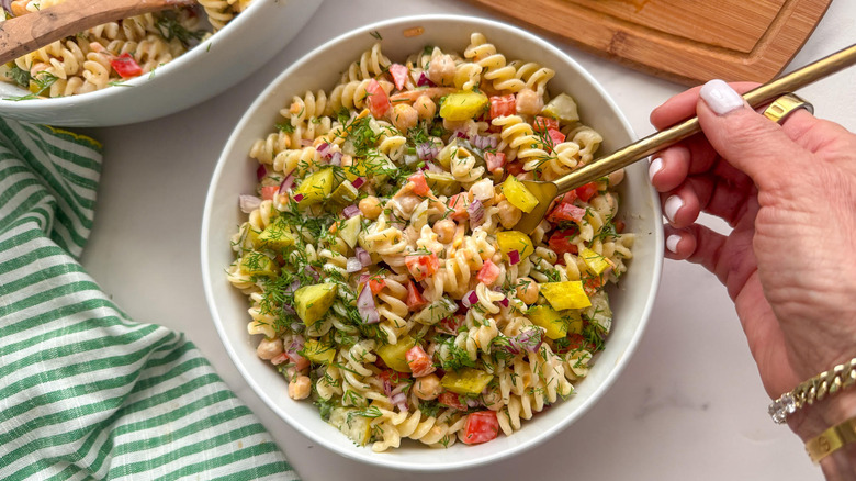 hand with fork in salad