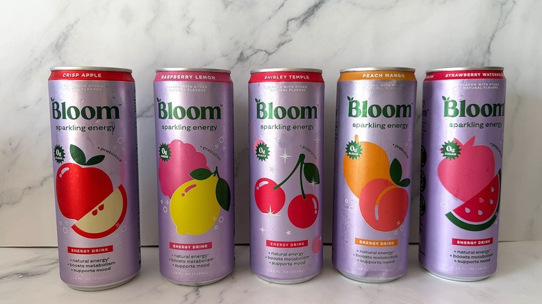 Five Bloom Sparkling Energy drinks on a marble background