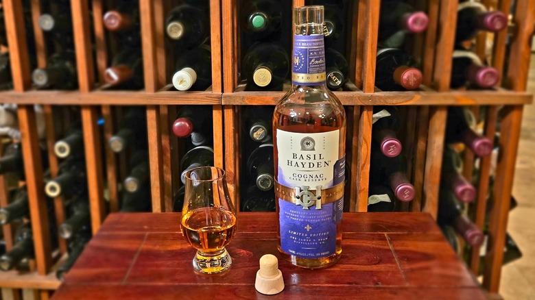 Bottle and Glencairn glass of Basil Hayden Cognac Cask Bourbon.