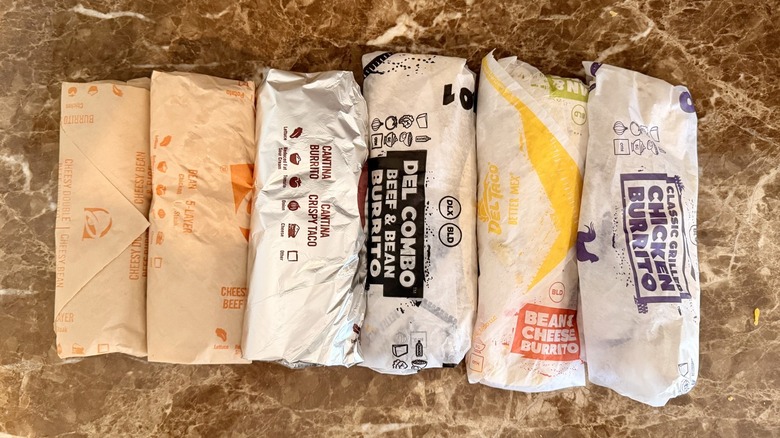 overhead shot of wrapped burritos from Del Taco and Taco Bell
