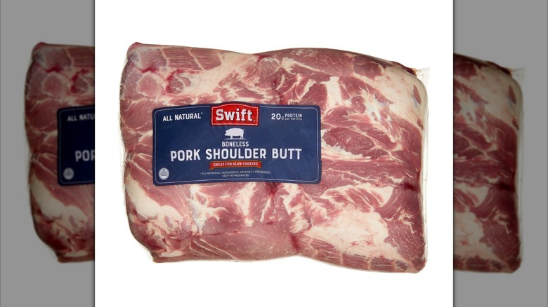 Kirkland Signature Boneless Pork Shoulder Butt wrapped in plastic on white background