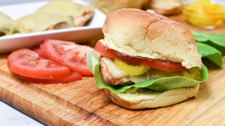 Marinated Grilled Chicken Sandwich on wooden cutting board