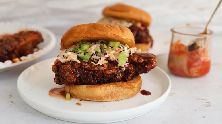 Saucy Korean Fried Chicken Sandwich on white plate