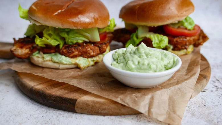 Shawarma-Spiced Grilled Chicken Sandwich on parchment paper with spread