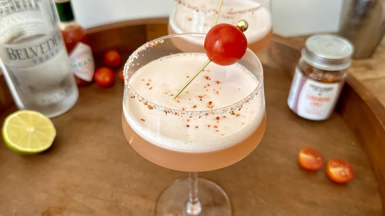 Spicy tomatini in glass with cherry tomato on skewer