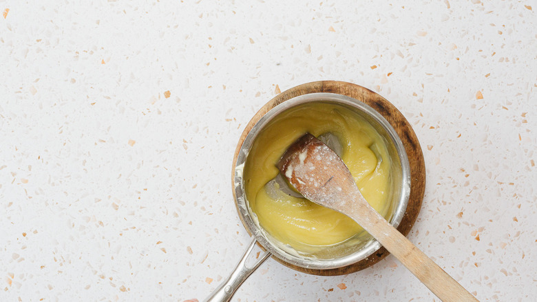 Saucepan with roux and wooden spoon