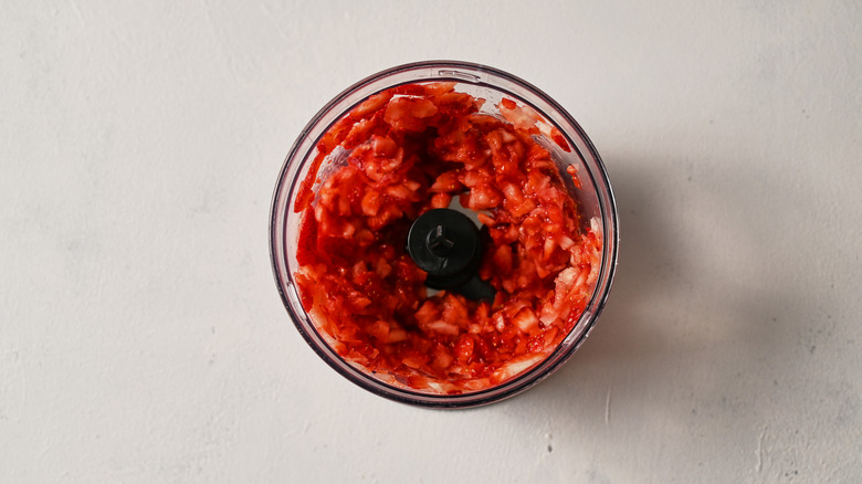 chopped strawberries in a processor