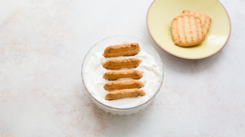 yogurt with cookies on table