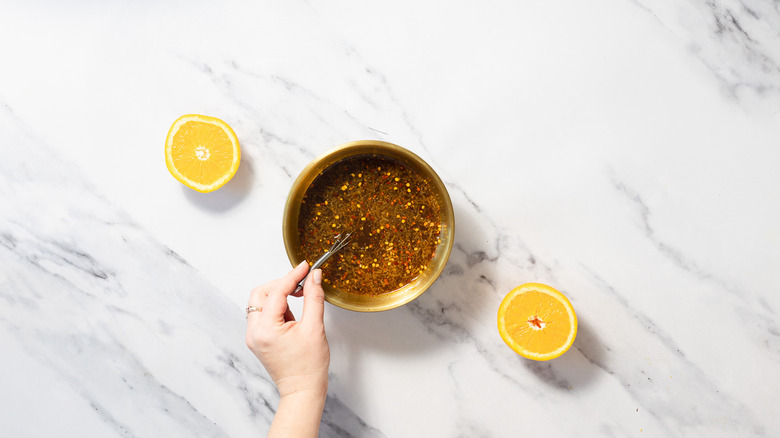 Whisking sauce in bowl