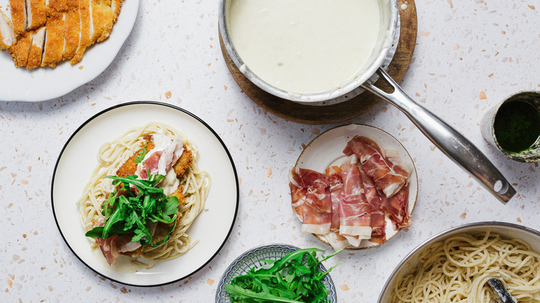 Chicken dish on white plate with components around