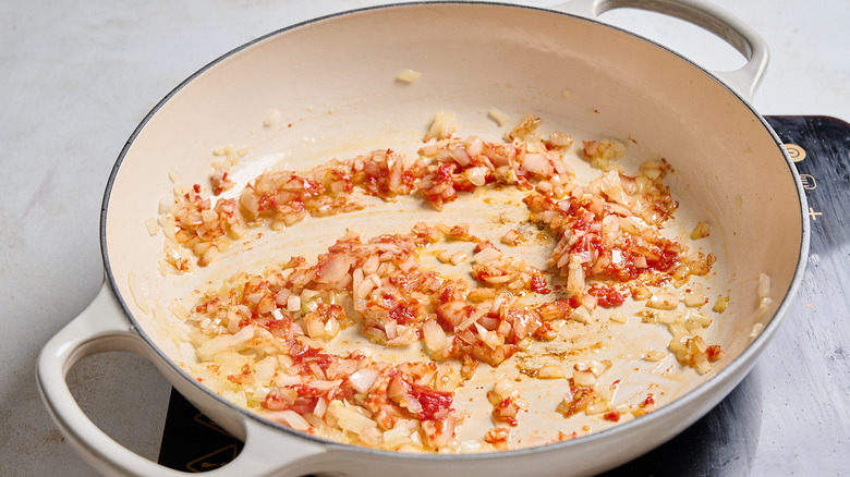 cooking tomato paste in a skillet