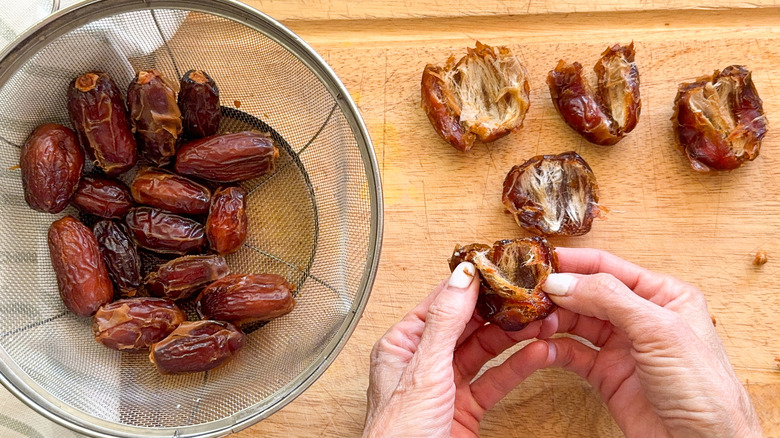 hands splitting open a date