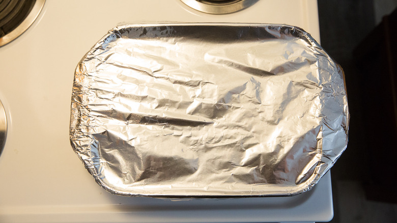foil-covered baking dish on stove