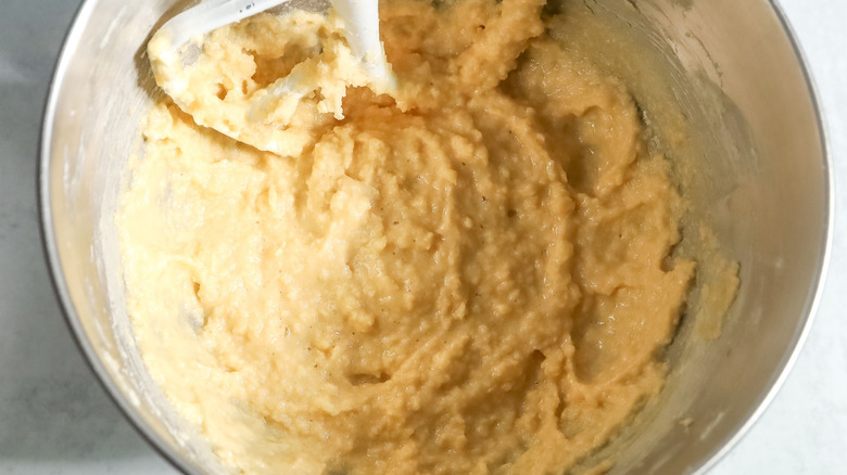 Butter, sugar, and egg mixture in stand mixer bowl with paddle attachment