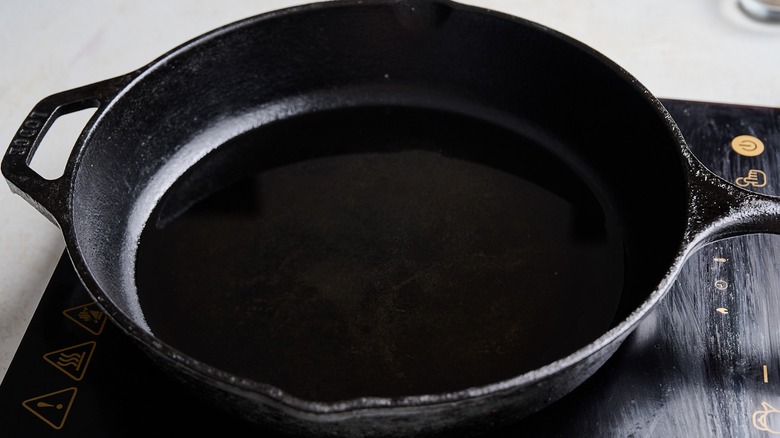 heating oil in a cast iron skillet