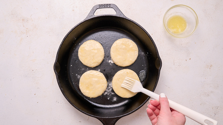 brushing biscuits with butter
