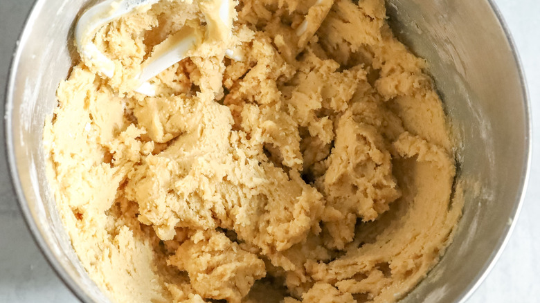 Cookie dough in stand mixer bowl with paddle attachment