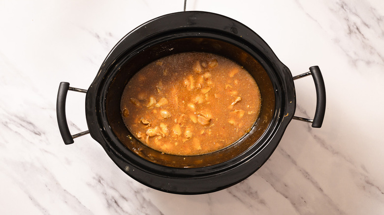 Cooked orange chicken in Crockpot