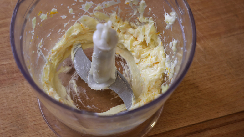 food processor with orange ginger compound butter in it