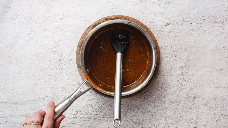 Glaze in saucepan with brush